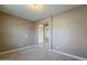 Bedroom featuring neutral carpet and an open doorway into an entry area with tile floors at 1203 E Judi St, Casa Grande, AZ 85122