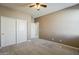 Bedroom featuring neutral carpet, fresh paint, a ceiling fan, and closet for ample storage at 1203 E Judi St, Casa Grande, AZ 85122