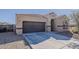 Inviting single-story home featuring a two-car garage, neutral color palette, and tile roof, perfect for modern living at 1203 E Judi St, Casa Grande, AZ 85122