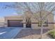 Charming single-story home with a two-car garage and desert landscaping in front at 1203 E Judi St, Casa Grande, AZ 85122