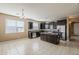 Bright kitchen featuring dark cabinetry, stainless steel appliances, granite counters, and a practical center island at 1203 E Judi St, Casa Grande, AZ 85122