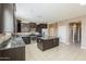 Contemporary kitchen with a central island, stainless steel appliances, dark wood cabinets, and tiled flooring at 1203 E Judi St, Casa Grande, AZ 85122