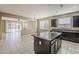 Open-concept kitchen showcasing a central island, granite countertops, and seamless flow to the living area at 1203 E Judi St, Casa Grande, AZ 85122