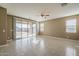 Expansive living room featuring tile flooring, a ceiling fan, and a sliding glass door leading to outdoor space at 1203 E Judi St, Casa Grande, AZ 85122