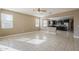 Open-concept living space with tile floors and abundant natural light seamlessly connecting the kitchen and living areas at 1203 E Judi St, Casa Grande, AZ 85122