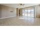 Spacious living room with tile flooring, lots of natural light, and access to the backyard through sliding glass doors at 1203 E Judi St, Casa Grande, AZ 85122