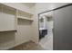 Walk-in closet with shelving provides lots of storage space; view into bathroom at 1203 E Judi St, Casa Grande, AZ 85122