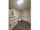 Bathroom with tile flooring, single sink vanity and marble tile bath surround at 12415 W Rock Springs Dr, Sun City West, AZ 85375