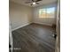 Clean and bright bedroom with wood-look tile floors and a ceiling fan for added comfort at 12415 W Rock Springs Dr, Sun City West, AZ 85375