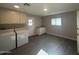 Functional laundry room with a washer, dryer, sink, and ample storage cabinets at 12415 W Rock Springs Dr, Sun City West, AZ 85375