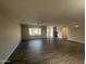 Spacious living room with wood-look tile flooring and ample natural light from a large window at 12415 W Rock Springs Dr, Sun City West, AZ 85375