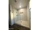 Modern walk-in shower with marble tile surround and glass door at 12415 W Rock Springs Dr, Sun City West, AZ 85375