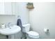 Clean and bright bathroom with pedestal sink and toilet at 13709 W Gunsight Dr, Sun City West, AZ 85375