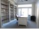 Bright home office with built-in shelving and a large desk at 13709 W Gunsight Dr, Sun City West, AZ 85375