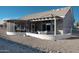 Covered patio with seating area and screened enclosure at 13709 W Gunsight Dr, Sun City West, AZ 85375