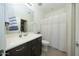 Clean bathroom, shower/tub combo, vanity with dark wood cabinets at 14870 W Encanto Blvd # 1014, Goodyear, AZ 85395