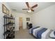 Bright bedroom with double bed, desk, and built-in shelving at 14870 W Encanto Blvd # 1014, Goodyear, AZ 85395