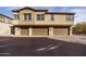 Exterior view of three-car garage and two-story building at 14870 W Encanto Blvd # 1014, Goodyear, AZ 85395