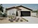 Single-story home with a two-car garage and desert landscaping at 18094 W Sand Hills Dr, Surprise, AZ 85387