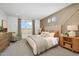 Main bedroom with plush bed, wood nightstands and accent chair at 18094 W Sand Hills Dr, Surprise, AZ 85387