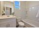 Clean bathroom with a single vanity, bathtub, and tiled shower surround at 18100 W Sand Hills Dr, Surprise, AZ 85387