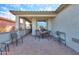 Inviting covered back patio with brick flooring and ample seating, perfect for outdoor entertaining at 1885 E Sycamore E Rd, Casa Grande, AZ 85122