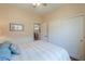 Spacious bedroom featuring wood floors, a ceiling fan, a closet and a large bed at 1885 E Sycamore E Rd, Casa Grande, AZ 85122