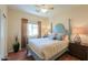 Comfortable bedroom showcasing wood floors, a ceiling fan, and blue accent furniture at 1885 E Sycamore E Rd, Casa Grande, AZ 85122