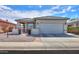 Charming single-story home features a well-maintained front yard, a two-car garage and tiled roof at 1885 E Sycamore E Rd, Casa Grande, AZ 85122