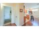 Inviting hallway featuring hardwood floors that leads to the open-concept kitchen and entry to the laundry room at 1885 E Sycamore E Rd, Casa Grande, AZ 85122