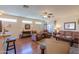 Bright and airy living room with hardwood floors, a ceiling fan, and comfortable seating at 1885 E Sycamore E Rd, Casa Grande, AZ 85122