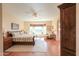 Bright main bedroom boasts a bay window, ceiling fan, and comfortable sitting area with a southwest view at 1885 E Sycamore E Rd, Casa Grande, AZ 85122