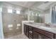 Double vanity bathroom with large walk-in shower at 21370 N 260Th Ln, Buckeye, AZ 85396