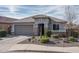 Single-story home with gray garage and desert landscaping at 21370 N 260Th Ln, Buckeye, AZ 85396