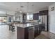 Spacious kitchen featuring granite countertops and dark brown cabinetry at 21370 N 260Th Ln, Buckeye, AZ 85396