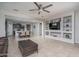 Open living room and kitchen area with tile flooring and ceiling fan at 21370 N 260Th Ln, Buckeye, AZ 85396