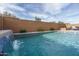 Inviting swimming pool with a waterfall feature and a brick wall at 21370 N 260Th Ln, Buckeye, AZ 85396