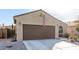 One-story house with brown garage door and desert landscaping at 2303 N General Dr, Florence, AZ 85132