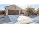 Home exterior featuring a brown garage door and gravel driveway at 2303 N General Dr, Florence, AZ 85132