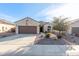 One-story home with brown garage door, landscaped yard, and American flag at 2303 N General Dr, Florence, AZ 85132