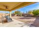 Covered patio with brick flooring, comfortable seating, and a grilling area at 2303 N General Dr, Florence, AZ 85132