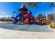 Modern playground with slides, climbing structures, and soft surface at 2303 N General Dr, Florence, AZ 85132