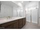 Bathroom featuring double sink vanity and glass enclosed shower at 24216 W Agora Ln Ln, Buckeye, AZ 85326