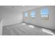 Spacious bedroom with carpet flooring, white walls, and large windows allowing ample natural light at 24216 W Agora Ln Ln, Buckeye, AZ 85326
