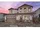 Two-story house with brown garage door and stone accents at 24216 W Agora Ln Ln, Buckeye, AZ 85326