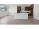 Bright kitchen with white walls, tile floors, a center island, stainless steel appliances and espresso cabinets at 24216 W Agora Ln Ln, Buckeye, AZ 85326