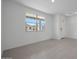 Bright living room with tile flooring, white walls, and a large window offering ample natural light and views at 24216 W Agora Ln Ln, Buckeye, AZ 85326