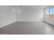 Bright living room with tile flooring, white walls, and a large window offering ample natural light and views at 24216 W Agora Ln Ln, Buckeye, AZ 85326
