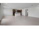 Open-concept living area connecting to a modern kitchen, featuring tile floors, white walls, and natural light at 24216 W Agora Ln Ln, Buckeye, AZ 85326