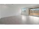 Spacious, bright living room featuring tile flooring, large windows, and a sliding glass door leading to the backyard at 24216 W Agora Ln Ln, Buckeye, AZ 85326